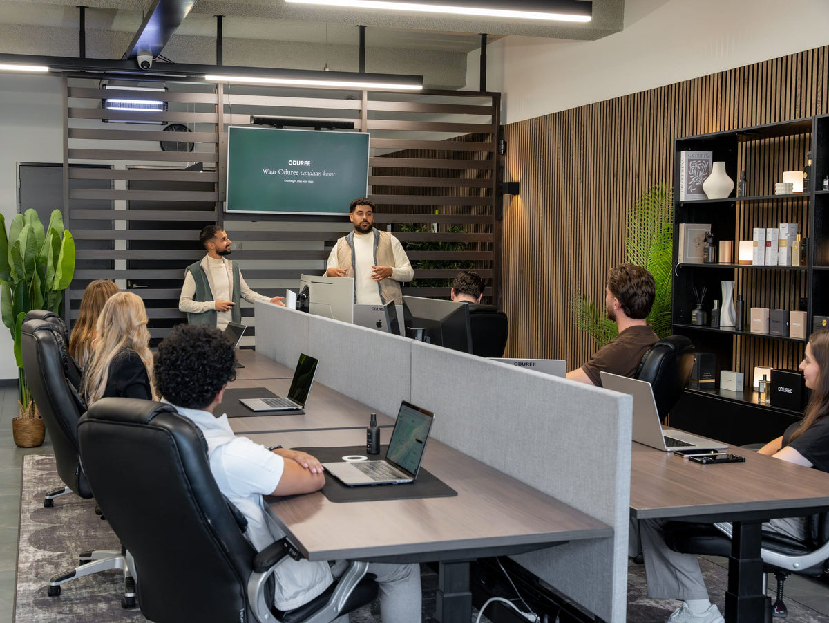The Oduree team in the office, at their desks during a presentation by the founders.