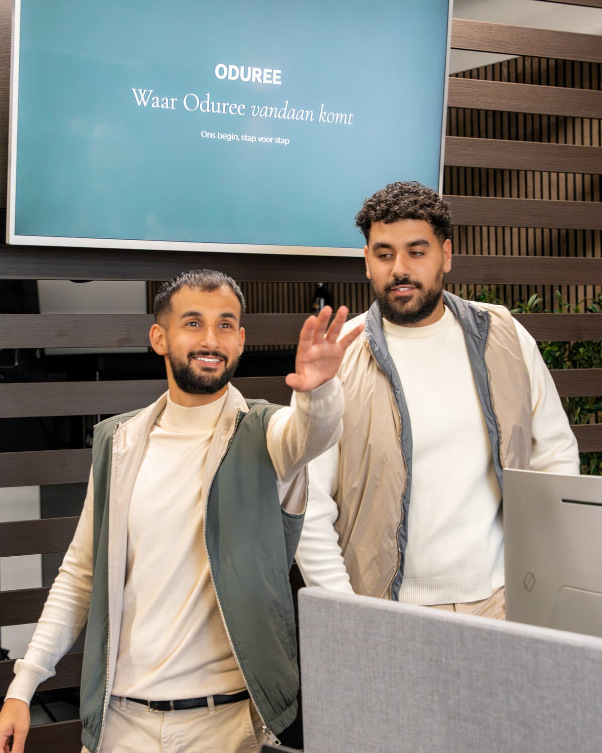 Marco and Kiro in the office, in front of a screen that reads Where Oduree comes from.