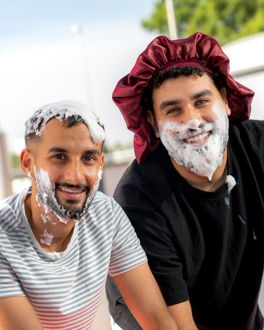 Marco and Kiro with foam on their faces at the car wash.