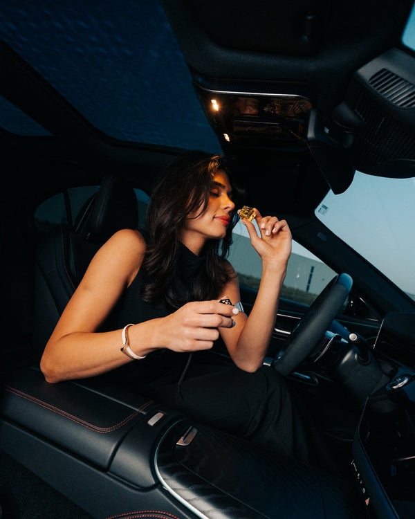 Someone smells the bottle in the car